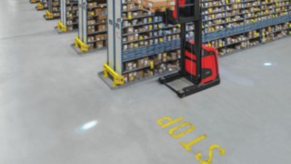 O BlueSpot da Linde projeta um ponto de luz azul no percurso, no sentido de marcha, alertando, assim, pessoas e os condutores de outros equipamentos para o equipamento que se aproxima. Imagem do BlueSpot da Linde, que projeta um ponto de luz azul no percurso, alertando, assim, pessoas ou outros operadores para o equipamento que se aproxima
